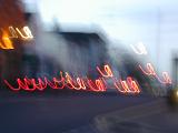 Creative blurry image of car lights bouncing and forming loops down city street
