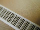 Bar code with product information for identification on brown textured paper in a diagonal full frame view