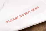 Please Do Not Bend postal label on a letter warning of fragile or important contents or documents