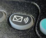 Voice mail sound alert button with envelope icon on a keypad in a close up view