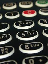 Close up view of an alphanumeric keypad on a black mobile phone with buttons in a communication concept
