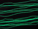 green coloured oscilloscope trace plotted on the graticule