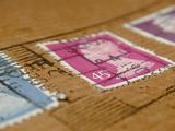 Low angle view of a cancelled British postage stamp on a brown paper wrapping with focus to the price of 45p