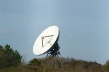 Large parabolic telecommunications antennae or dish on a hilltop on the skyline in a communications concept