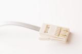 Plug of phone connector cable against white background