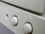 Eject and fast forward buttons on white media equipment in a close up view conceptual of personal entertainment and technology