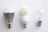 Three options for electric lighting with LED, fluorescent and incandescent light bulbs in a row over white