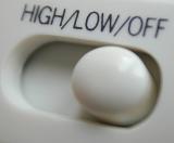 White plastic slider level switch annotated High - Low - Off in a close up view on the button on electronic equipment