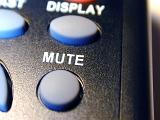 close up of the mute button on a remote control commander