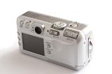 Old silver digital compact camera viewed high angle from the rear showing the viewfinder and controls in a concept on photography
