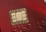 Macro view of the smart chip on a red bank credit card for identification and authentication of transactions for payment