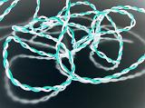 Glowing bright twisted wire of cyan and white colors reflecting in glass surface, close-up background concept
