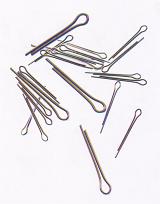 Scattered metal stationery pins or clips for filing paperwork on a white background conceptual of an office or business