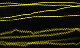 Yellow noise lines plotted on an oscilloscope screen