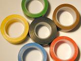 Set of various colorful insulating tapes arranged as a flower, viewed in close-up