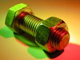 Bolt with a nut in close-up lit up with colorful green and red lights