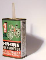 Tin of 3-in-one lubricating motor oil for chains and bearings on a white background with shadow