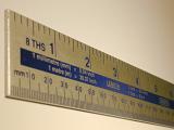 Rule with metric and Imperial measurements with the scale marked in both centimetres and inches in a oblique receding view