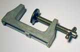 The metal clamp with plastic press framed diagonally and viewed in close-up on white background