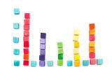 Learning about the bar graph with childrens wooden toy building blocks stacked and arranged as a colourful bar graph