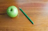 education background, an apple on a wooden school desk