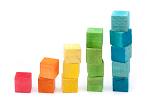 Toy blocks used to teach young children how to count arranged in colourful stacks with one to five blocks in a specific colour in each tower