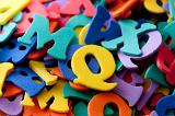 Closeup background of a collection of multicoloured plastic uppercase letters in a shooling, teaching, learning and education concept