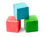 Red, blue and green wooden building blocks, closeup over white background