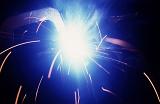 bright blue glow and sparks from an arc welder