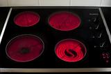 four hotplates on an electric glass cooktop