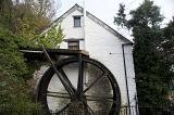 historic water powered mill with an overflow wheel
