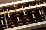 Detail of a wooden abacus with its counters for manual computing and accounting