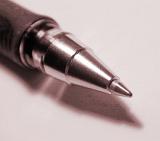 Close up of the silver metal nib of a ballpoint pen casting a shadow on a white background, square format