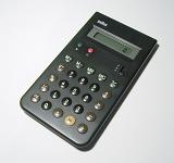 Close up on single calculator with liquid crystal display for numbers over gray background