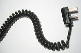 Spiral black cord with British plug displayed in a wavy line over white