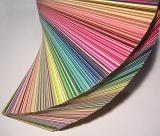 Fanned book of Design color swatches or sample cards for fashion and interior decor viewed close up from above
