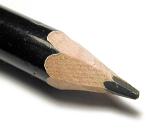 Sharpened black wooden pencil point in a close up macro view over white with shadow