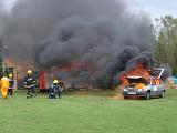 fire fighters attending to a demonstration car fire