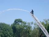 a fire engine ladder, fireman and water from a hose