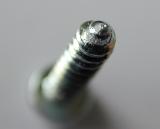 Abstract screw with focus to the tip of the spiral thread as it stands in an upright position