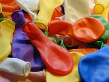 Close Up Detail of Rainbow Colored Deflated Balloons in Festive Party Concept Background Image