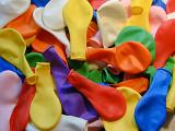 Background composed of colorful plastic flat balloons in blue yellow orange and purple