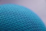 Close up on texture of little blue ball or curved tight shape with gray background