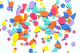 Colorful foam oval and rounded triangle shapes colored orange blue and yellow against a white background