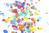 Scattering of little blue, purple, red and yellow foam craft shapes over white background