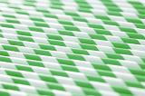 Full frame background of tightly packed close row of green and white straws with copy space