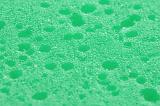 Full frame backround of green pool of liquid with surface bubbles or permeable type sponge texture