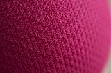 Close up on texture of little pink ball or curved tight shape fading into background