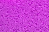 Extreme close up of deep purple sponge with darker pock marks
