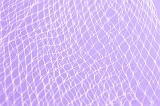 Close up of white plastic netting against light purple background